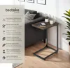 A side table next to a sofa, with text describing its features. Náhled obrázku produktu