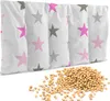 A product shot of a cherry stone pillow with a pile of cherry stones in front of it. Produktbild-Vorschau