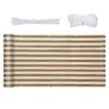 A rolled-up balcony privacy screen with brown and white stripes, along with zip ties and rope, laid out on a white background. Podgląd zdjęcia produktu