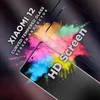 A close-up marketing image of a screen protector for a Xiaomi 12 phone, with colorful powder exploding in the background. Produktbild-Vorschau