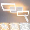 A modern white LED ceiling light with a geometric design, shown on a light gray ceiling. A remote control is also visible. Produktbild-Vorschau