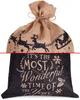 A Christmas sack with a Santa and reindeer design on the top half and a festive quote on the bottom half. Anteprima dell’immagine prodotto