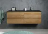 A modern bathroom vanity with a wooden cabinet and black double sinks against a concrete wall. Anteprima dell’immagine prodotto