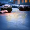 Three illuminated star-shaped garden stakes are placed in the snow in front of bushes and a house. Produktbild-Vorschau