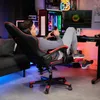 A man is relaxing in a gaming chair with his feet up, holding a phone. Náhled obrázku produktu