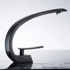 A black modern faucet with a curved design is shown against a white background, with water droplets visible. Podgląd zdjęcia produktu