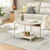 A living room scene with a couch, coffee table, and rug. Produktbild-Vorschau