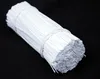A bundle of white twist ties on a black background. Produktbild-Vorschau