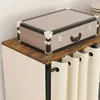 A close-up view of a vintage-style suitcase placed on top of a wooden shelf. Produktbild-Vorschau