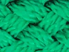 A close-up, abstract view of woven green material, possibly a horse net. Produktbild-Vorschau