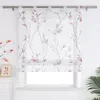 A sheer Roman blind with a branch and leaf pattern is shown hanging in front of a window. Produktbild-Vorschau