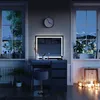 A vanity table with an LED mirror and stool in a dimly lit room, with windows showing a snowy landscape at night. Náhľad obrázku produktu