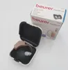 A hearing aid is shown open in its case, with its packaging box in the background. Podgląd zdjęcia produktu