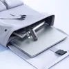 A laptop, notebook, and USB-C adapter are neatly arranged inside an open backpack. Náhľad obrázku produktu