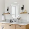 A modern bathroom vanity with a mirror, sink, and accessories. Voir les images du produit