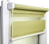 A close-up view of a green roller blind installed in a window frame. Produktbild-Vorschau