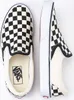 A pair of Vans checkerboard slip-on shoes are shown from a top-down perspective against a white background. Voir les images du produit