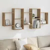 A wooden wall shelf unit mounted on a white wall above a sofa. Voir les images du produit