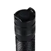 Close-up view of the top of a black flashlight, showing the button and part of the body. Produktbild-Vorschau