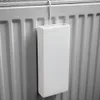A white ceramic humidifier hangs from a radiator. Produktbild-Vorschau
