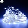 A close-up shot of a string of white LED lights coiled on a dark surface. Produktbild-Vorschau