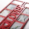 A close-up, angled view of a red multi-photo frame with the word "LOVE" spelled out in large letters across it. The frame has multiple openings for photos, some of which contain decorative paper inserts. Náhľad obrázku produktu