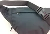 A close-up view of a black hip bag with a black strap and buckle. Anteprima dell’immagine prodotto