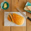A marble serving platter with sliced bread and butter on a wooden table. Produktbild-Vorschau