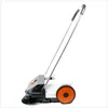 A side view of a white and orange manual sweeper on a white background. Podgląd zdjęcia produktu