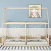 A wooden house-shaped bed frame with two mattresses and pillows, set against a blue and white star-patterned wall. Anteprima dell’immagine prodotto