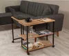 A side table with a laptop, coffee cup, book, and water bottle next to a sofa. Voir les images du produit