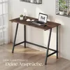 A modern desk with a laptop, plant, and coffee cup in a well-lit room. Produktbild-Vorschau