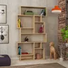 A modern, light wood bookshelf filled with books and decorative items, placed against a textured gray wall. Podgląd zdjęcia produktu
