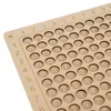 A close-up view of a wooden multiplication table with engraved numbers. Produktbild-Vorschau