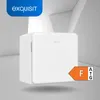 A white mini-refrigerator is shown against a modern, abstract background with geometric shapes and shadows. Produktbild-Vorschau
