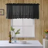A black lace valance hangs over a window, with a table set with a wine bottle, glass, and plates in the foreground. Produktbild-Vorschau