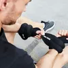 A person is putting on wrist weights. Produktbild-Vorschau