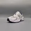 A single New Balance sneaker is shown against a plain gray background. Voir les images du produit