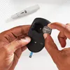 A person is inserting a coin cell battery into a black device, with a white medical device in the background. Anteprima dell’immagine prodotto