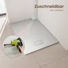 A shower tray is shown in a bathroom setting, with a close-up inset of a tool being used to cut it. Náhľad obrázku produktu