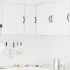 A clean, white kitchen corner with upper cabinets and a tiled backsplash. Voir les images du produit