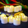 A group of LED tea lights are arranged on top of a book, with a colorful blurred background. Produktbild-Vorschau