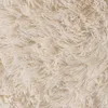 A close-up view of a fluffy, cream-colored carpet. Produktbild-Vorschau