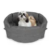 A Shih Tzu dog sits in a gray fabric pet carrier. Produktbild-Vorschau