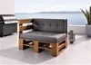 An outdoor patio with a view of the ocean, featuring a pallet sofa and a grill. Produktbild-Vorschau