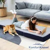 A woman and a dog are lying on a foldable mattress in a living room. Voir les images du produit