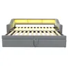 A grey sofa bed with an open mattress platform and yellow LED lighting above the headboard, displayed against a white background. Voir les images du produit