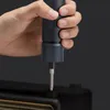 A hand is holding an electric screwdriver and using it on a black electronic device. Podgląd zdjęcia produktu