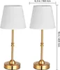 Two identical gold table lamps with white fabric shades are displayed side-by-side against a white background. Produktbild-Vorschau