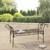 A metal garden bench sits on a wooden deck in an outdoor setting with lush greenery in the background. Anteprima dell’immagine prodotto